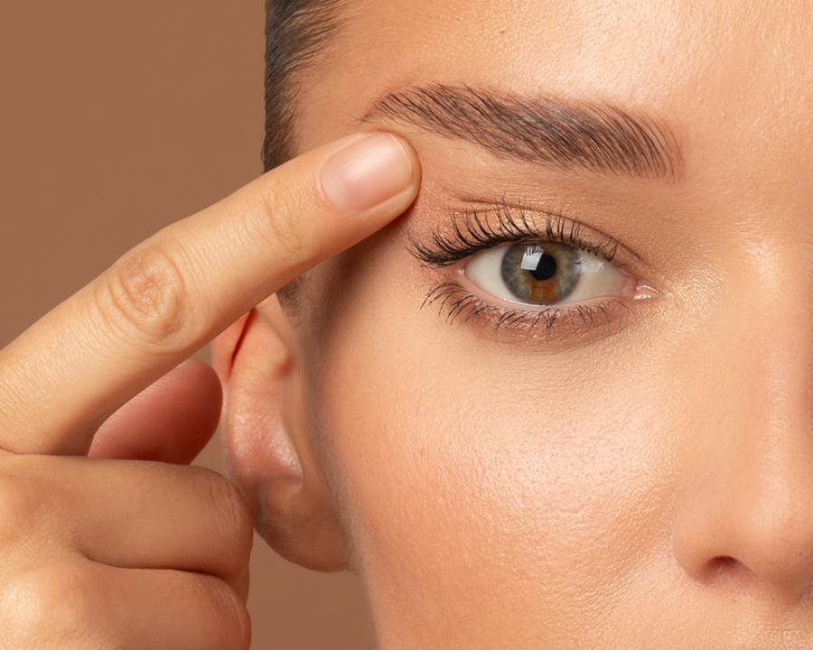 Woman raising her upper eyelid